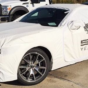 Karma wrapped in transport cover @ dealership, after unloading from hauler